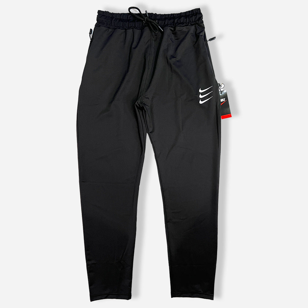 black trouser with zipper pockets and elastic waistband and nike logo on it.