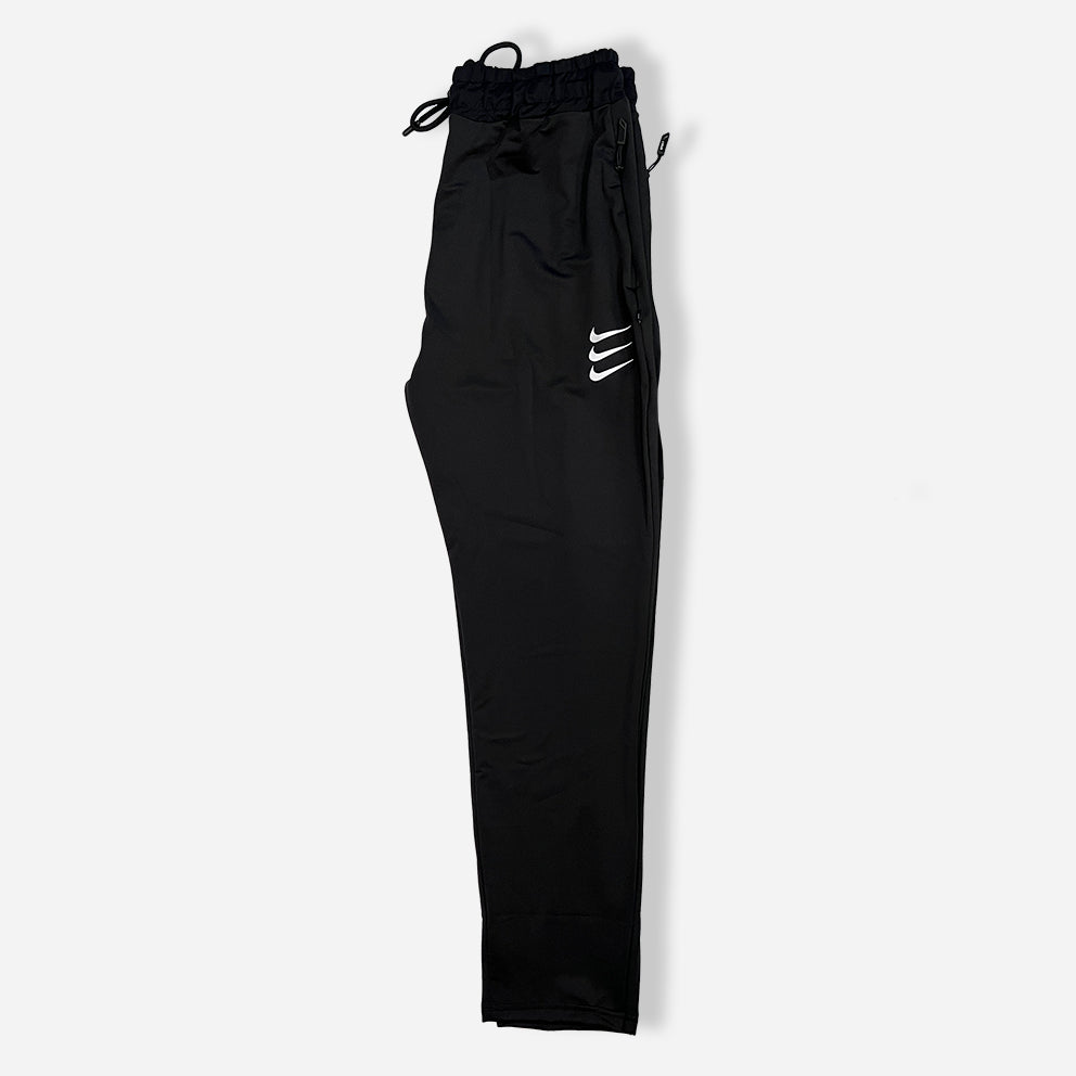 side pack black trouser with zipper pockets and elastic waistband and nike logo on it.